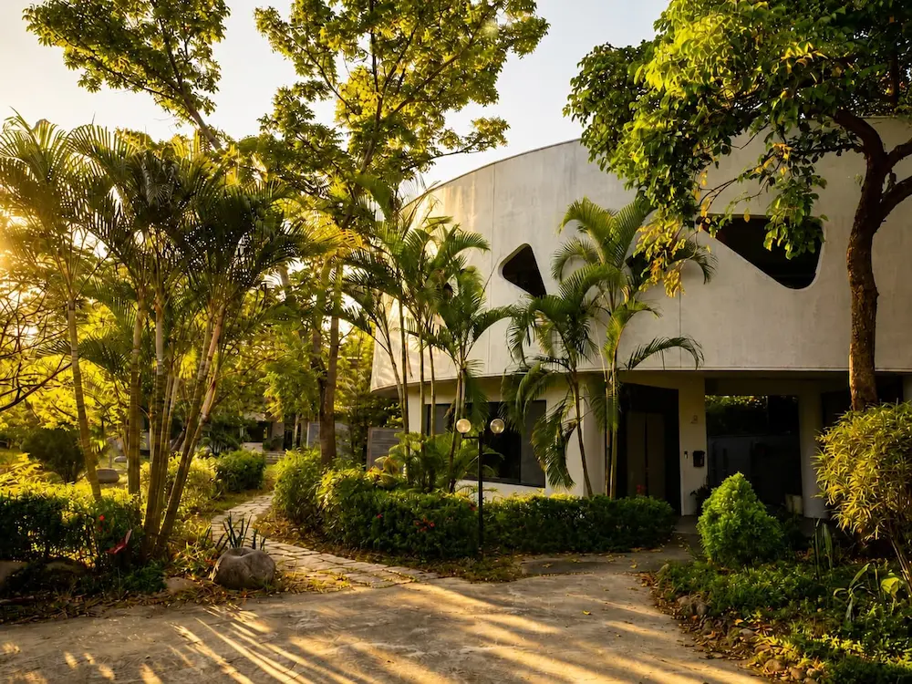 The Ánanda Suruci Yoga Retreat Center among trees and gardens