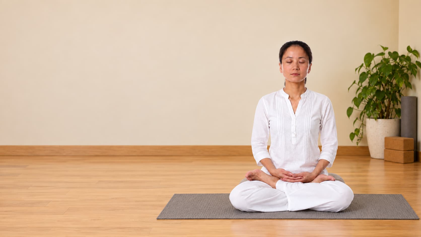 A person meditating quietly indoors