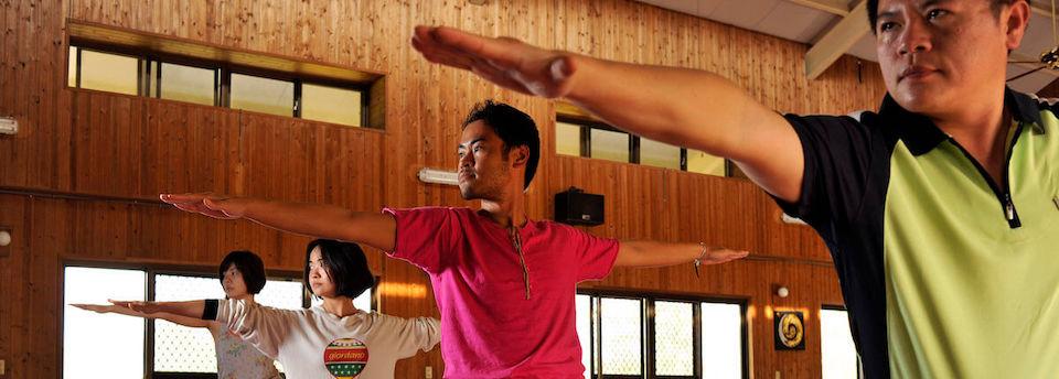 A group practicing yoga stretches indoors